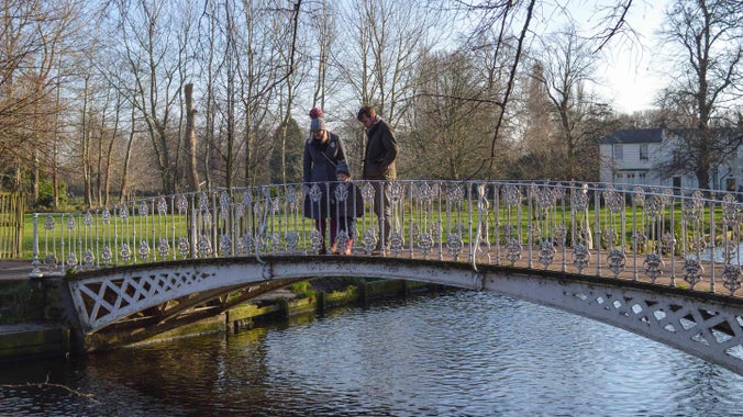 A family on the bridge at Morden Hall Park, London